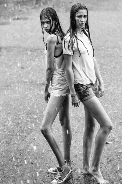 Две хорошенькие девушки под дождем — стоковое фото