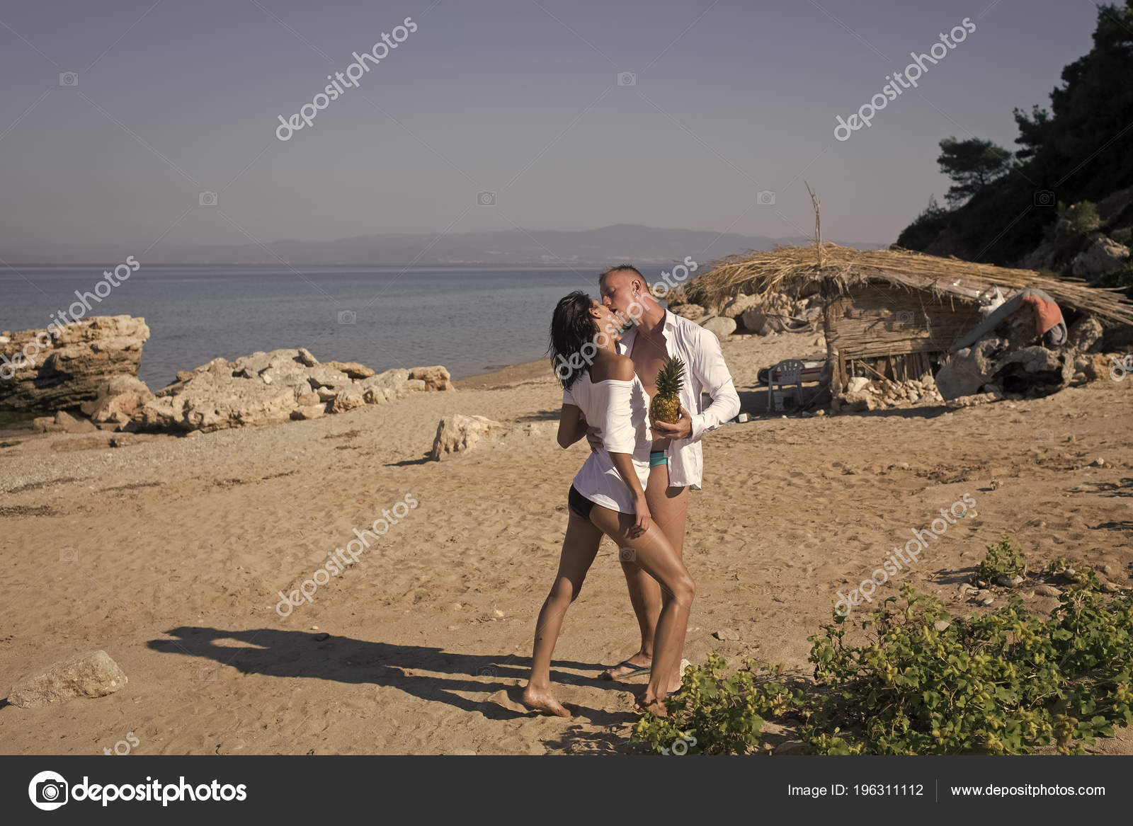 Beach Couple Kissing Naked - Tropical honeymoon concept. Passionate couple on vacation ...