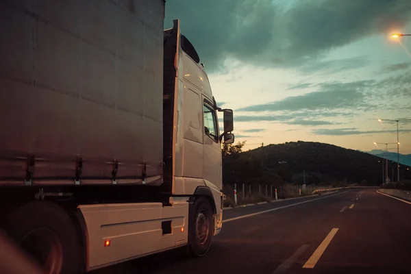 Argo van, lastbil, kamion transporter varor eller artiklar mellan länder. Internationell transport konceptet. Camion, van Rider längs vägen i kvällen, bakre se — Stockfoto