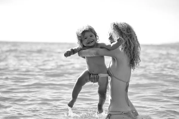 Kids enyoj happy day. Woman in bikini with child — Stock Photo, Image