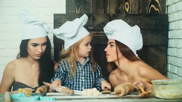 女同性恋夫妇和他们领养的孩子一起做饭。姐妹烹调与他们的弟弟 — 图库视频影像