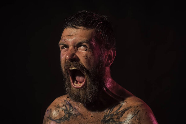 Handsome man face. Bearded man with angry face shout on black background