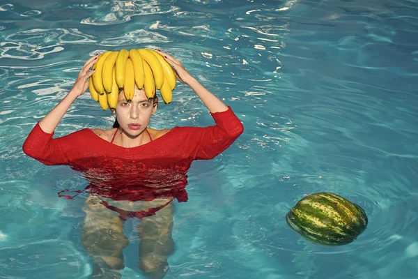 Beauté du visage de femme. Fille tenant pastèque et banane dans la piscine bleue, style instagram. Régime aux fruits tropicaux. Vacances d'été idyllique — Photo