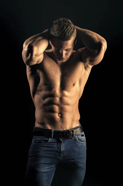 Mens heals body care. Man sportsman show muscular torso in jeans on black background — Stock Photo, Image