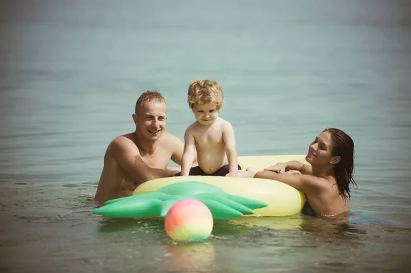 夏休み 海への旅行 パイナップル インフレータブルまたはエアコンのマットレス モルディブまたはマイアミ ビーチ活動の喜び 父と息子と母は 水でボールをプレーします カリブの海に幸せな家族カップル — ストック写真