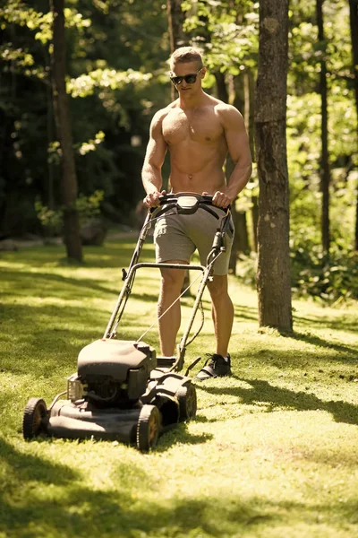 Male Face. Issues affecting boy. Man athlete mow lawn with grass cutter