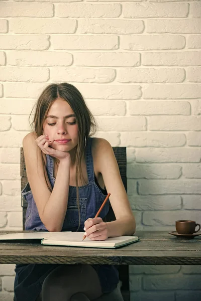 Mujer feliz. Mujer joven sentada a la mesa de madera — Foto de Stock