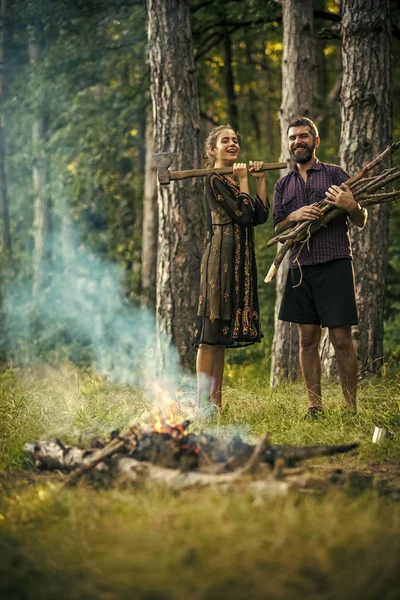 Couple in love. Man with bunch of firewood