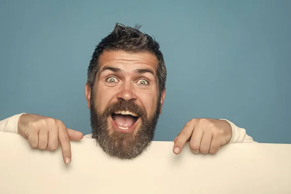 Handsome man face. man with long beard on happy face with paper