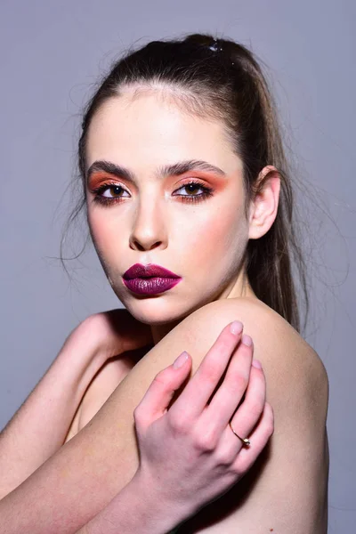 Makeup for model with soft skin. makeup on face of cute woman with bare soulders