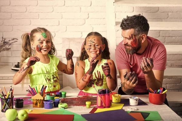 Meninas e homem com as mãos e rostos pintados — Fotografia de Stock