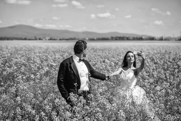Sensuele liefde spel. Verliefde paar. bruidspaar in veld gele bloemen — Stockfoto