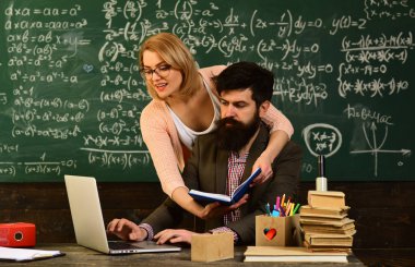 Güzel öğretmen öğrenci ilkokul, uluslararası öğrenci online test, bireysel yapma evde özel ders sırasında masanın oturan öğretmen sınıfta yardım,