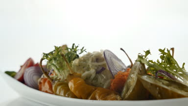 Salata beyaz tabak, koyu ahşap arka plan görev yaptı. Restoran yemek kavramı. Restoranda yemek.