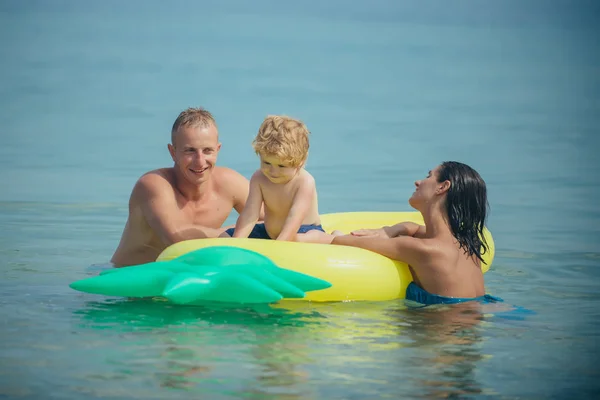 Pineapple inflatable or air mattress. pineapple mattress and happy family on summer vacation.