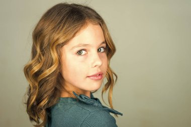 gri arka plan üzerinde poz şık güzel bir çocuk. Yüz çocuk dergisinin kapağı için. Kız çocuklar yüz portre, advertisnent içinde.