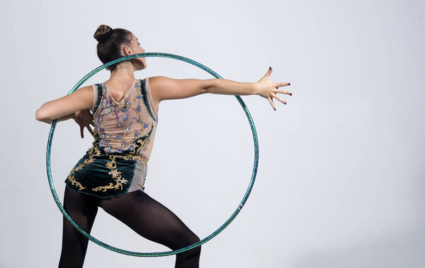 brunette woman doing exercise with a hula-hoop. Fitness woman