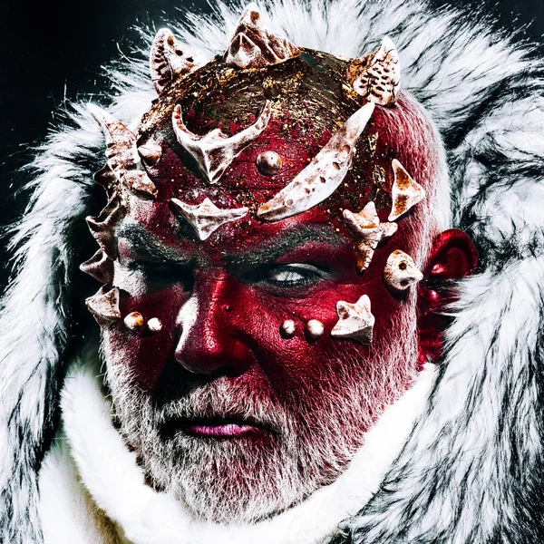 Demon with red face, sharp thorns and white fur over dark background. Mystical enchanted creature living in perpetual cold. Guardian of permafrost land, fairy tale concept
