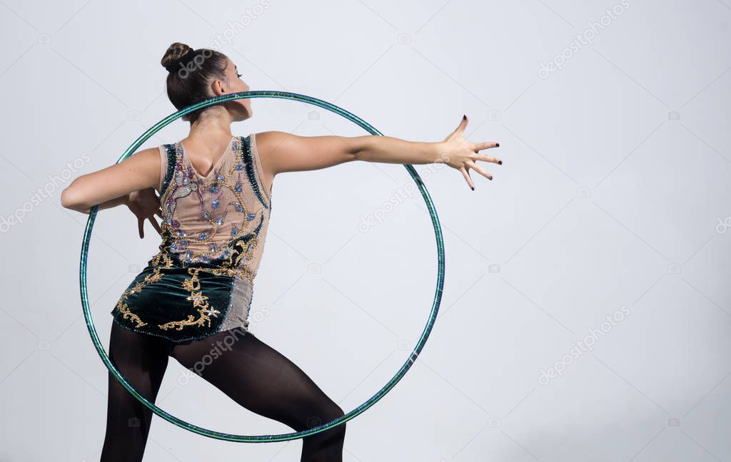 brunette woman doing exercise with a hula-hoop. Fitness woman