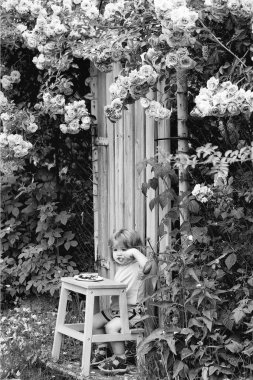 Çocuk çocukluk çocuklar mutluluk kavramı. küçük çocuk gül bush yeme