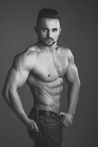 Bodybuilder athlétique homme sur fond gris . — Photo