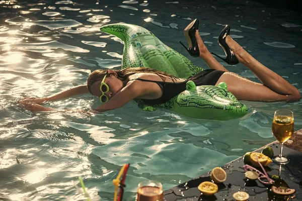 Relájate. mujer con colchón inflable en forma de cocodrilo que va a nadar. En vacaciones divertirse y relajarse en la playa . —  Fotos de Stock