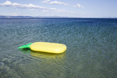 Denizde şişme yatak float. Hava güneşli deniz manzarası üzerinde mavi su yatağı. Plaj yaz tatili. Seyahat veya gezi ve yolculuk tutkusu. Keşif ve macera