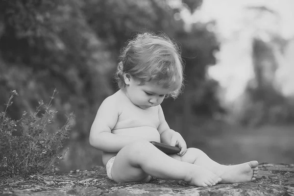 Miúdo feliz a divertir-se. Bebê brincando com telefone celular — Fotografia de Stock