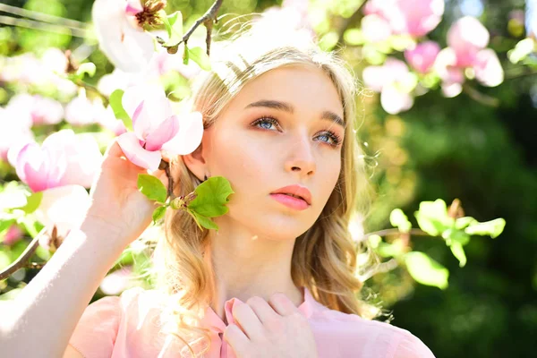 Chica huele flores de magnolia rosa primavera soleada. chica con hermosa flor de magnolia — Foto de Stock