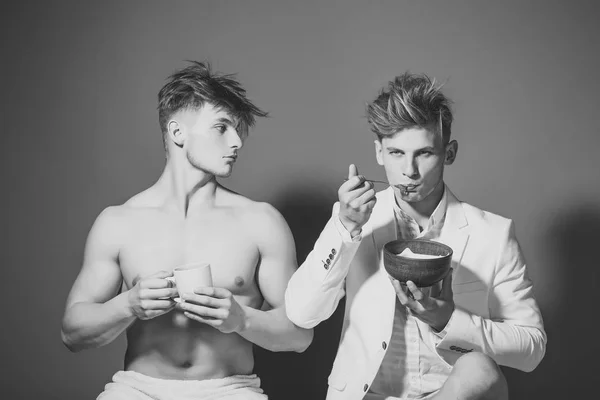 Bachelors. Twins with muscular body in jacket with cup and bowl. — Stock Photo, Image