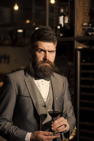 Wine taster. perfect wine. wine glass in hands of serious bearded man in formal suit — Stock Photo, Image