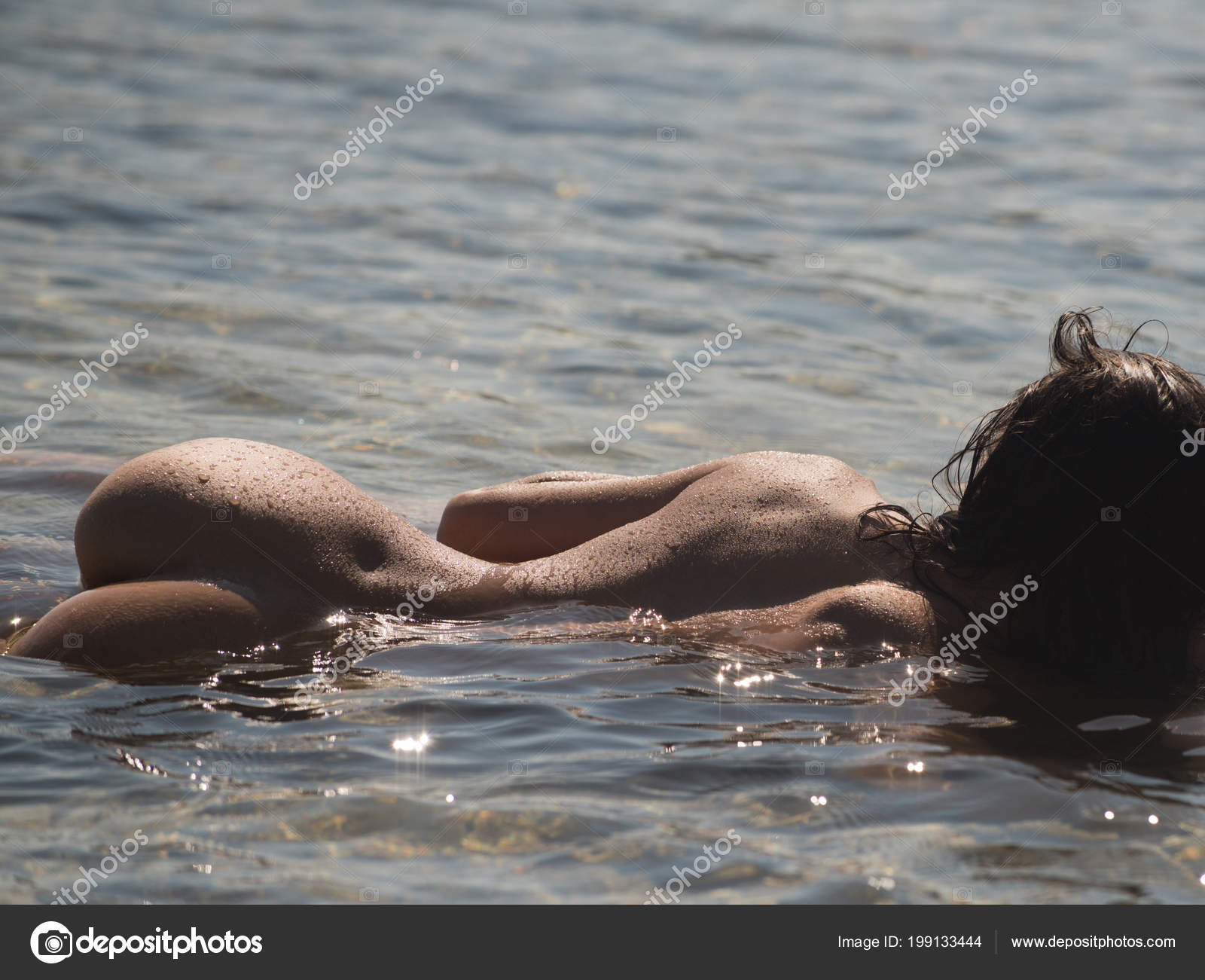 Sensual woman with sexy body relax on beach. naked girl with buttocks in sea water. Sex games and seduction image