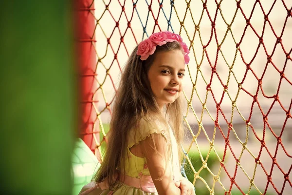 Child in the playroom. Girl child with pink flowers in hair spring. — Stock Photo, Image