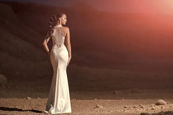 elegant wedding dress. Woman in white wedding dress in desert