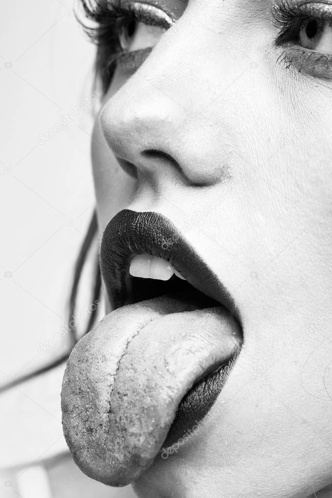 woman shows the tongue. Sexy female lips