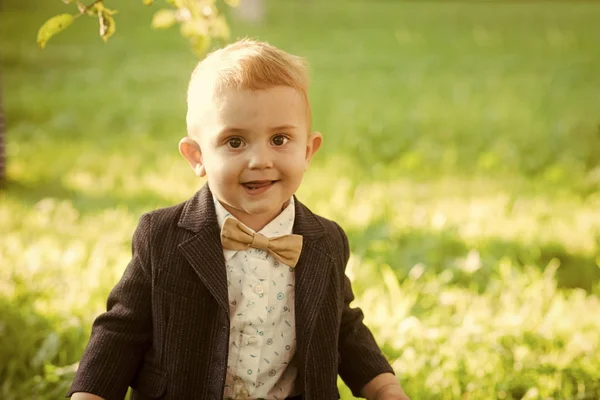 Vacation, activity, lifestyle. Little boy with bowtie on natural landscape, fashion — Stock Photo, Image