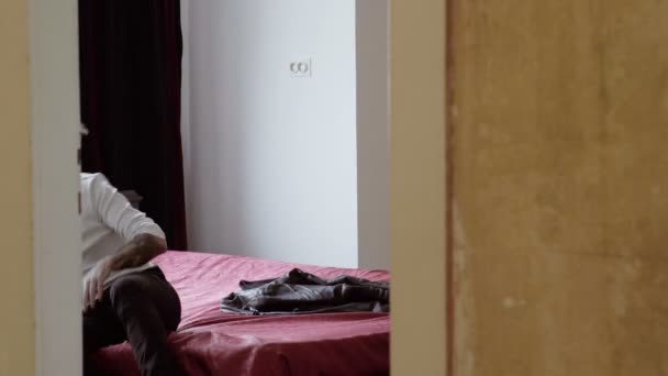 Obosit om odihnindu-se pe pat în cameră — Videoclip de stoc