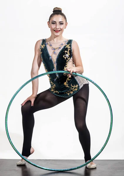 Woman with gymnastic ring. Woman train acrobatics with hula hoop in sportswear. Fitness and dieting of girl gymnast. Workout sports activities in gym of flexible girl. Sport success and health