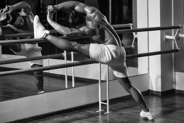 Инструктор по фитнесу. мускулистый человек делает упражнения на растяжку — стоковое фото