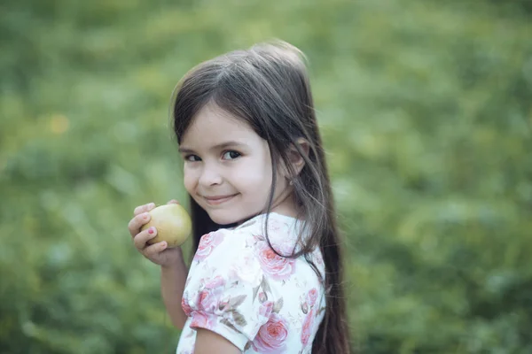Child smile with green apple fruit on nature, food — Stock Photo, Image