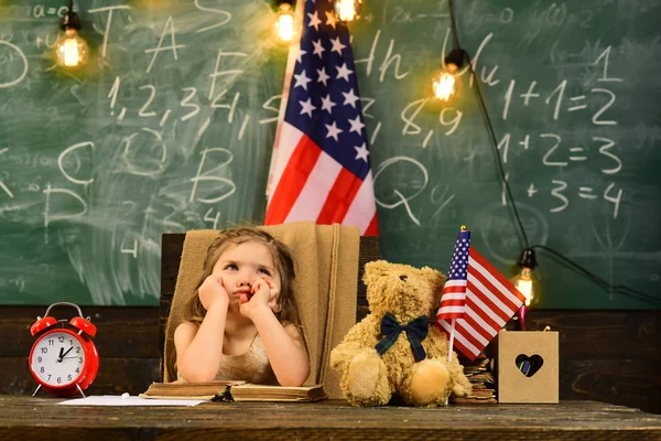 Zufriedene Schüler bei der Unterrichtsstunde mit US-Nationalflagge. Anreicherungsklassen können für einige Kinder schwierig sein, also sind Nachhilfelehrer die besten. Kinder lernen oft leichter durch den Einsatz von Bildern und räumlichem Verständnis — Stockfoto