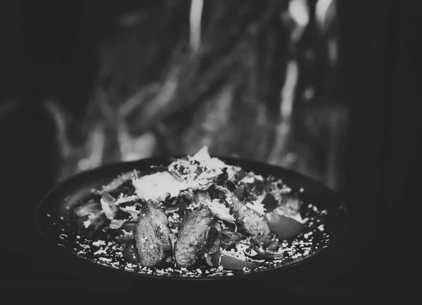 Conceito de restaurante prato. Prato de carne de vaca ou vitela servido com folhas de alface, tomates e polvilhado com queijo parmesão, fogo no fundo. Carne deliciosa servida em restaurante em pratos pretos — Fotografia de Stock