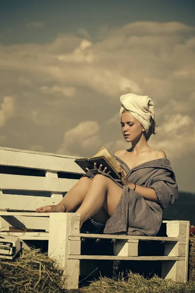 Concepto de spa y bienestar. Mujer leyendo libro en el banco — Foto de Stock