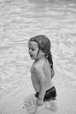 Çocuk yüzme vardır. Şirin neşeli bebek çocuk banyo açık yüzme havuzunda vardır.