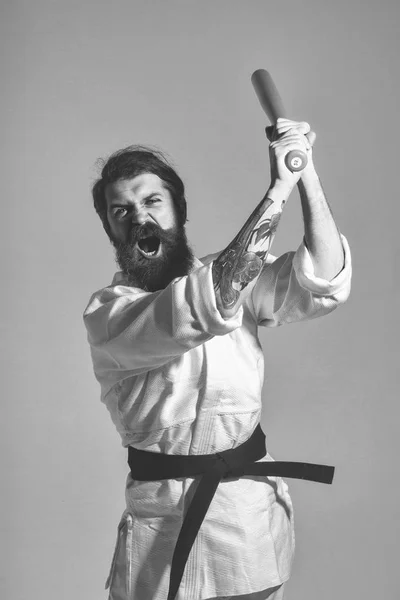 Martial arts. bearded shouting karate man in kimono with green baseball bat — Stock Photo, Image