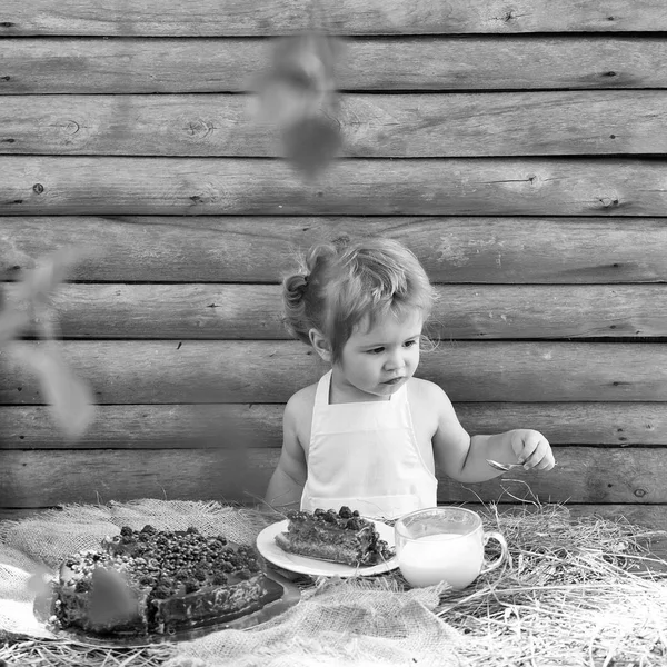 A criança está a comer um bolo. Menino come bolo de frutas — Fotografia de Stock