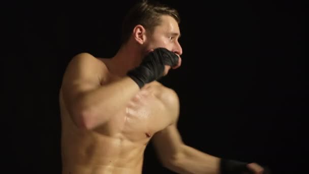 Strong boxer on a black background. Boxing. — Stock Video