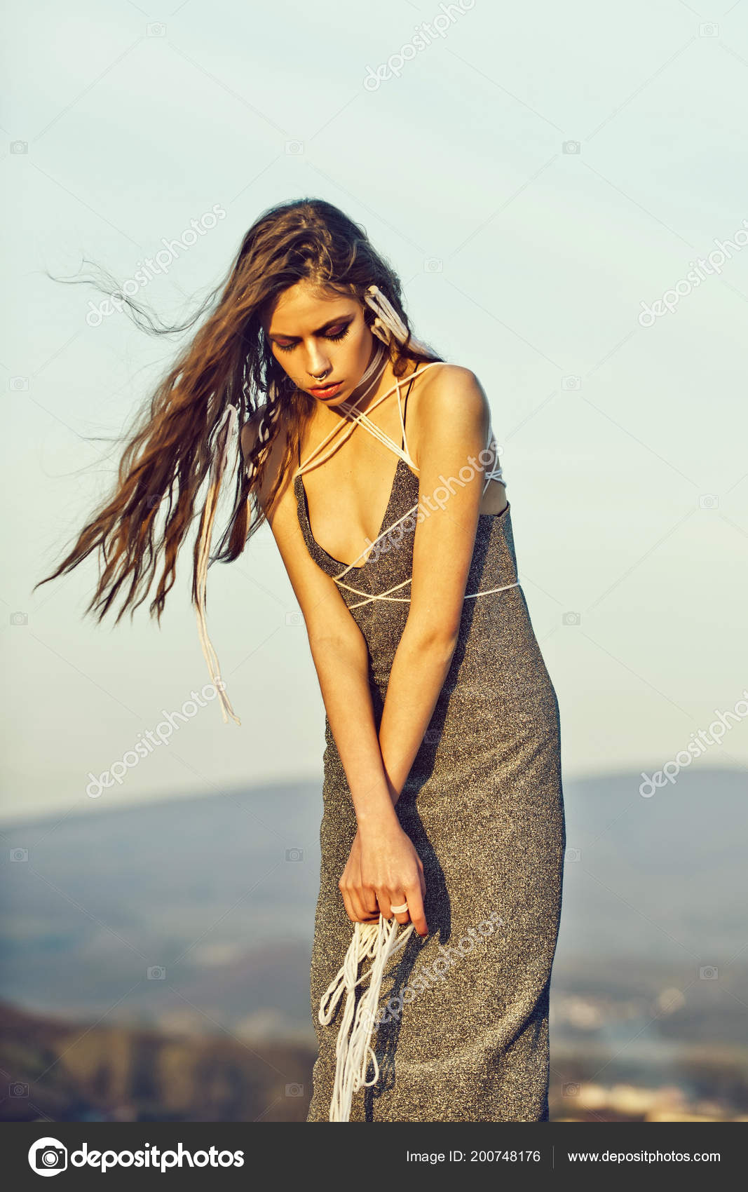 Sensual woman. girl standing with white strings in long, hair Stock Photo by