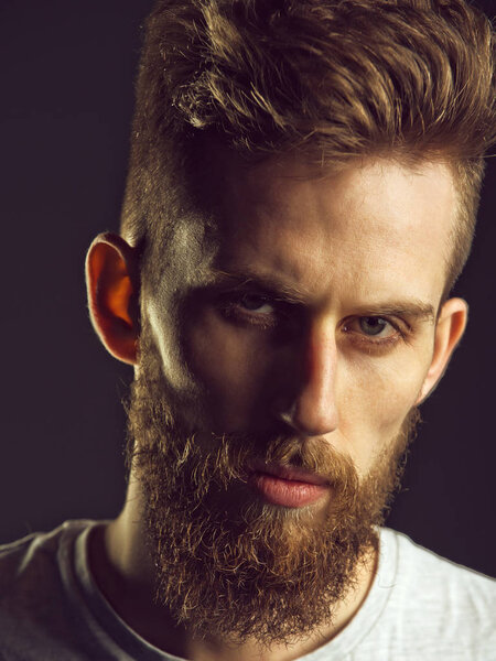 Beauty fashion portrait. man, bearded young hipster has mustache on serious face