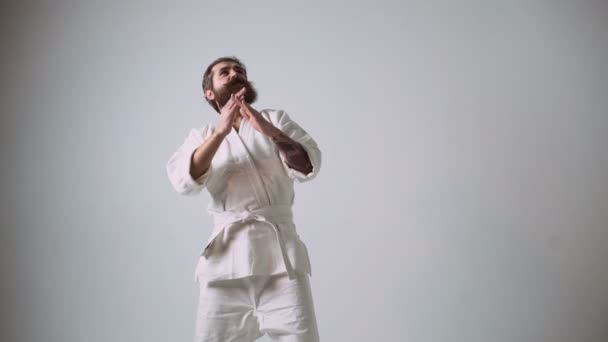 Awkward karate waving his hands and beating himself in the groin — Stock Video